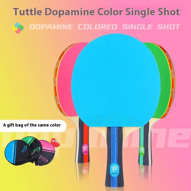 Blue, green, and pink shakehand grip table tennis rackets with matching racket covers laid out.