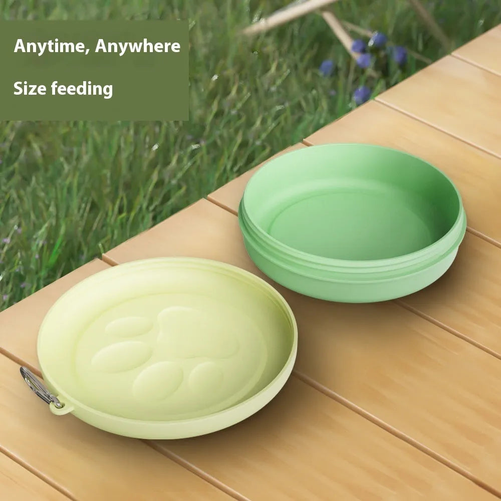 Two-tone portable dog bowl with attached snack box for outdoor feeding.