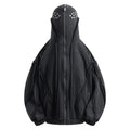 Man wearing a loose black zip-up hooded coat with a padded lining.