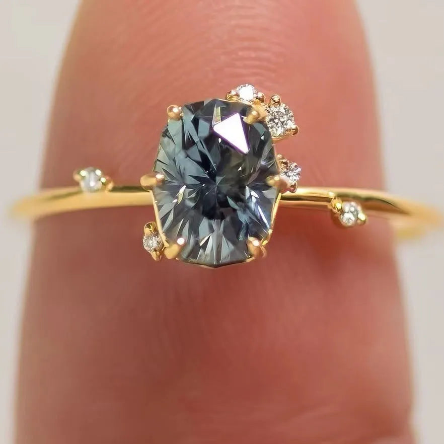 Gold plated floral fashion ring with green zircon stone inlay on finger