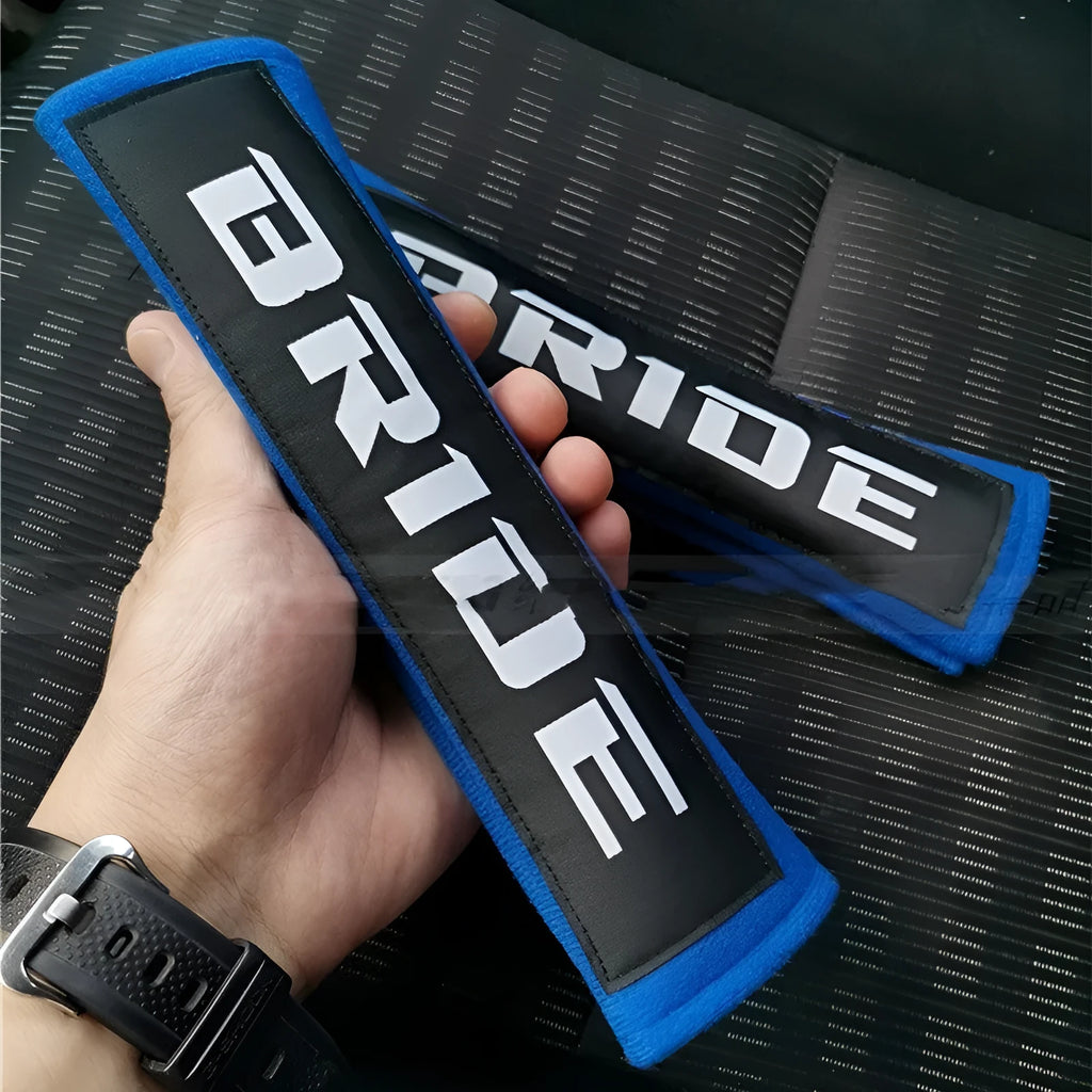 Car seat belt shoulder pad set in black, blue, or red colours with sponge padding and decorative embroidery