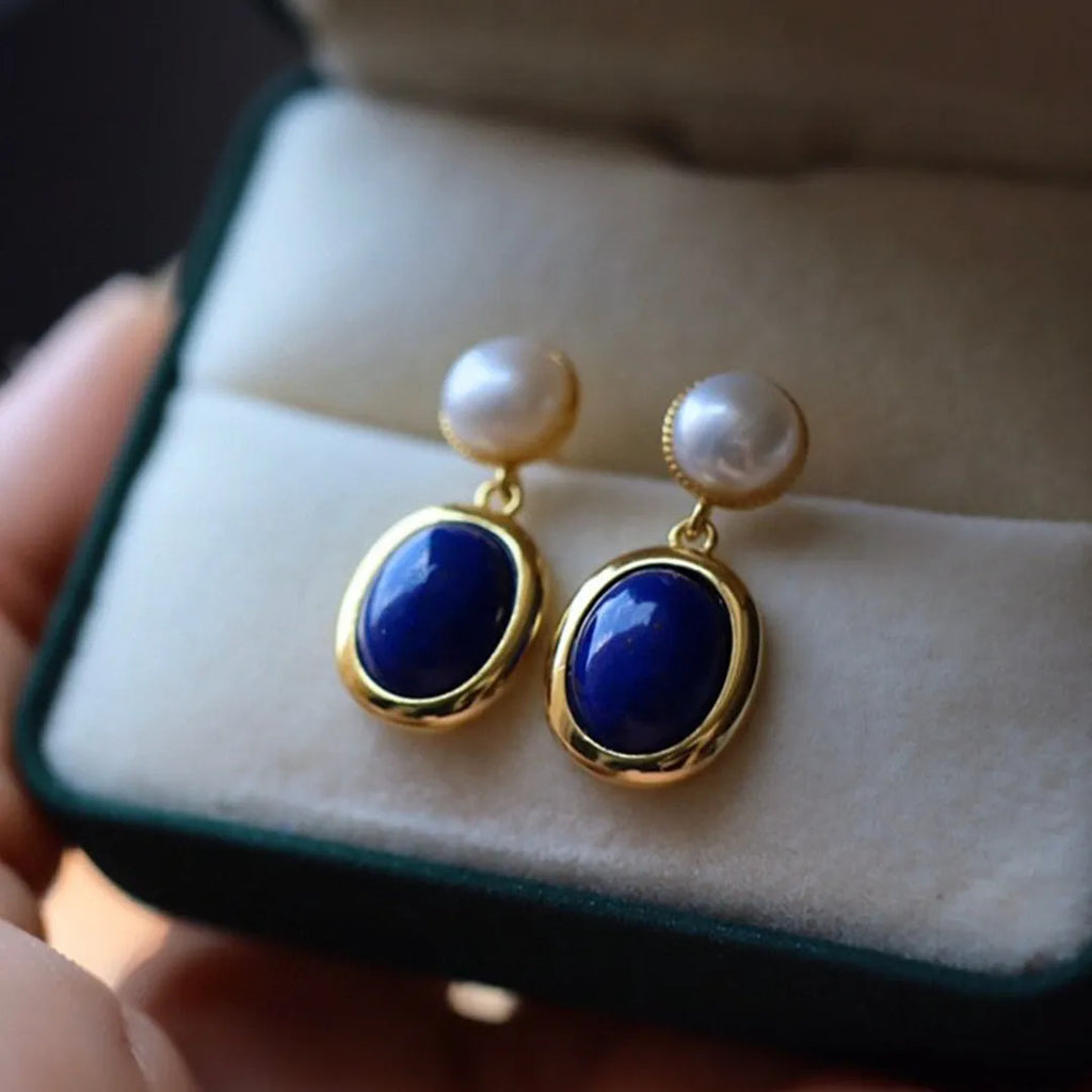 A pair of simple 925 silver drop earrings with a blue lapis lazuli pearl and auspicious patterns.