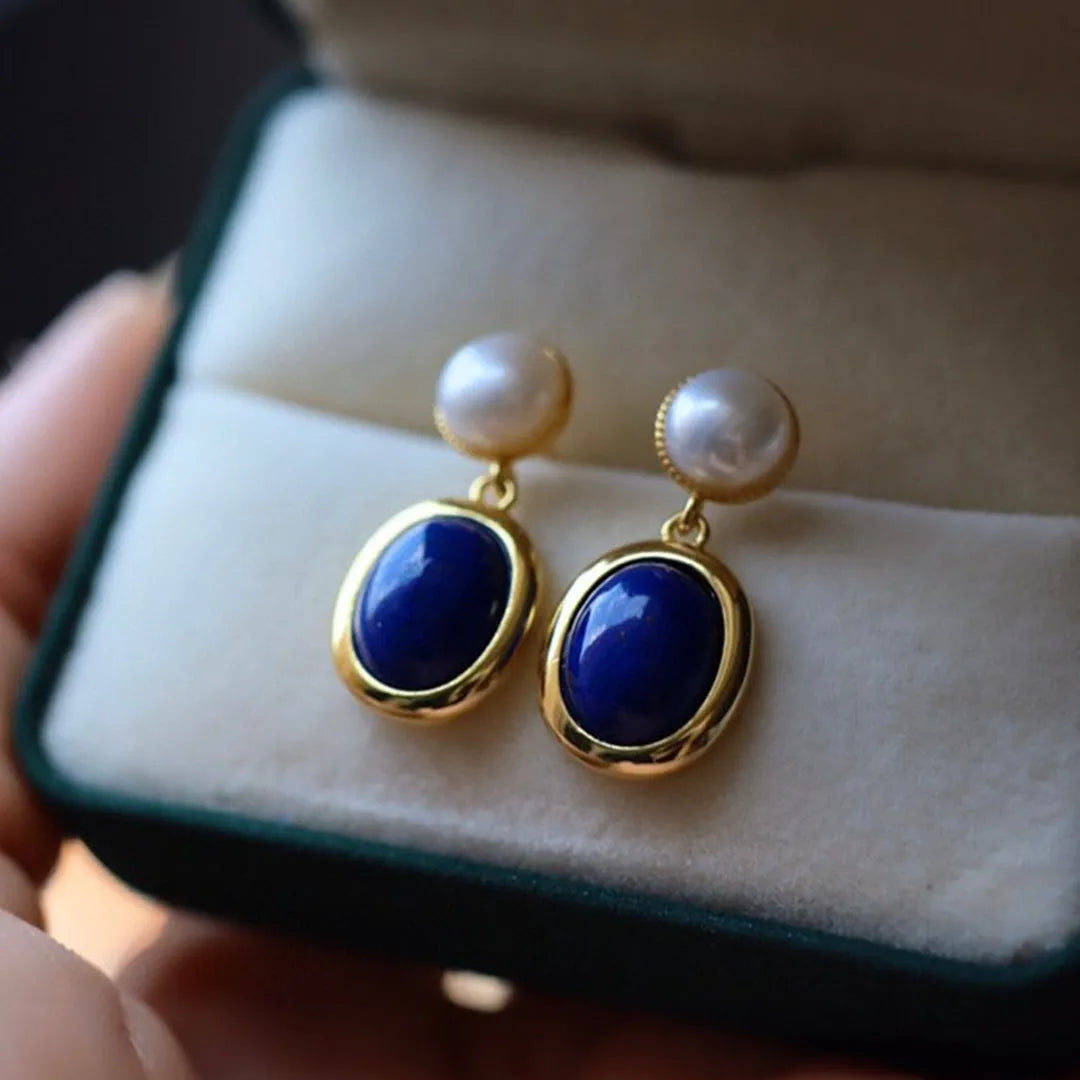 A pair of simple 925 silver drop earrings with a blue lapis lazuli pearl and auspicious patterns.