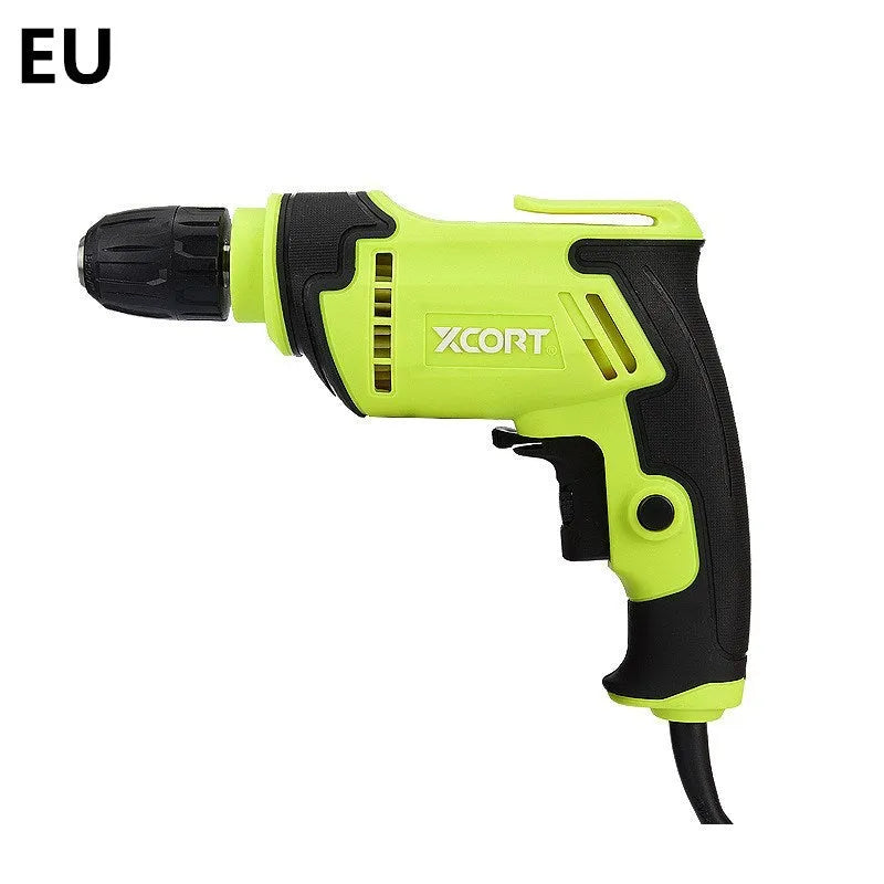 Pistol-grip electric power drill with a black and orange casing on a workbench.
