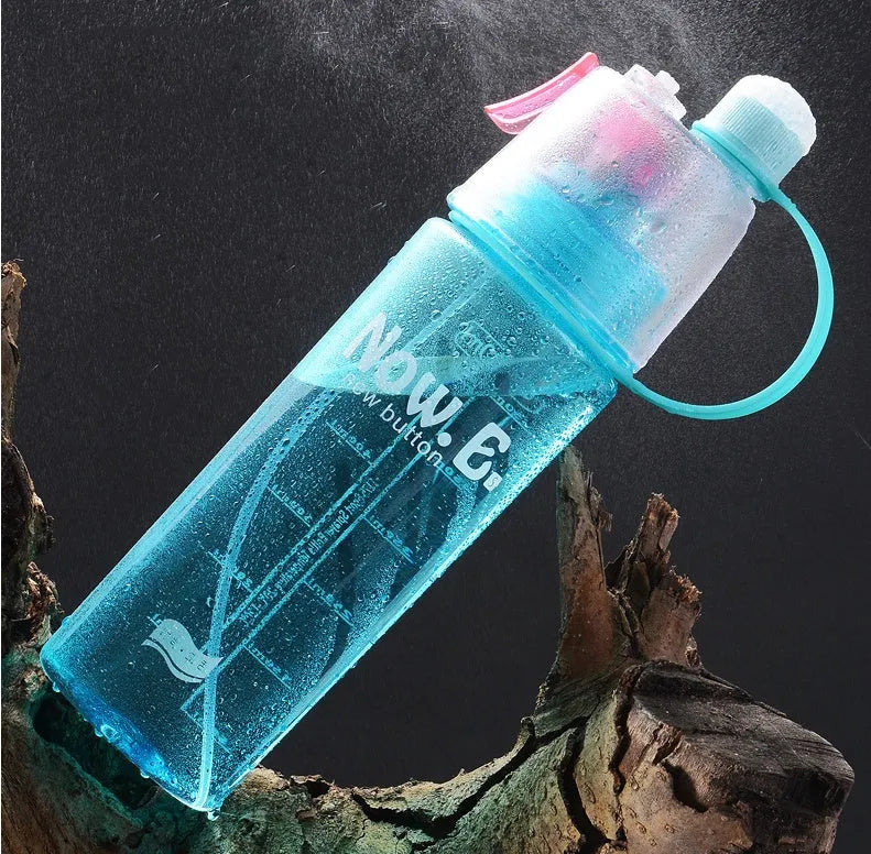 Portable outdoor sports mist spray cup with handle, transparent body showing scale markings, and spray mouth
