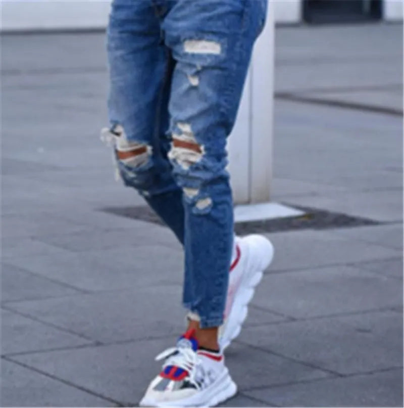 Men's deep blue cotton jeans with hole distressing, shown flat