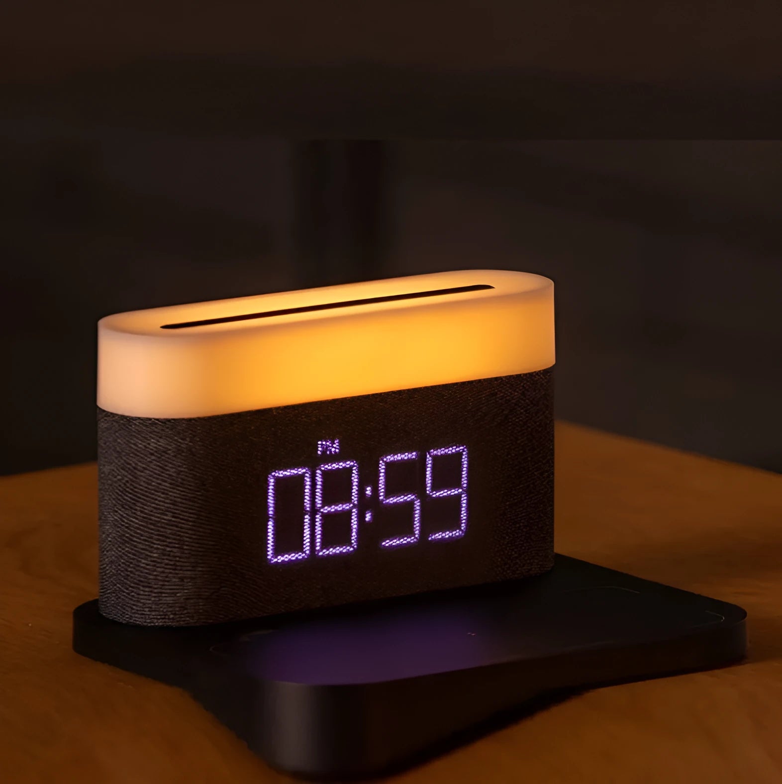 White bedside table lamp with integrated digital clock and wireless phone charging pad on base.