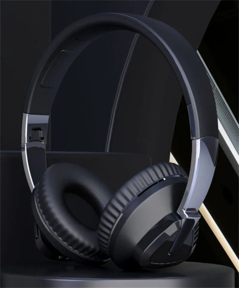 Wireless Bluetooth over-ear headphones in black colour with all-inclusive ear design showing AUX port and control buttons