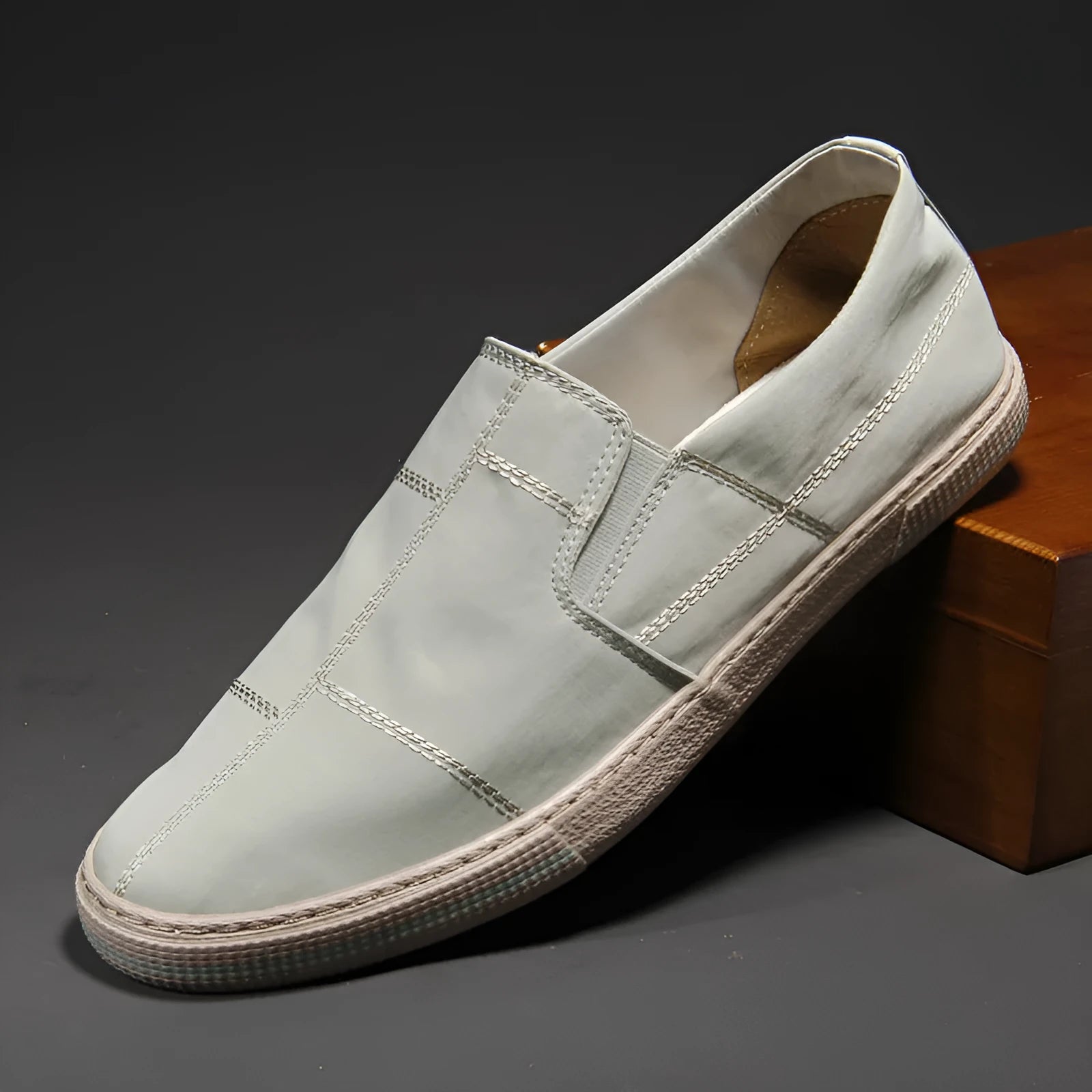 Men's low-top slip-on canvas shoes in khaki colour with a vulcanised rubber sole and rounded toe.