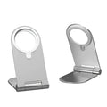 Silver vertical adjustable magnetic phone bracket for iPhone 12 shown in a car and on a desk.