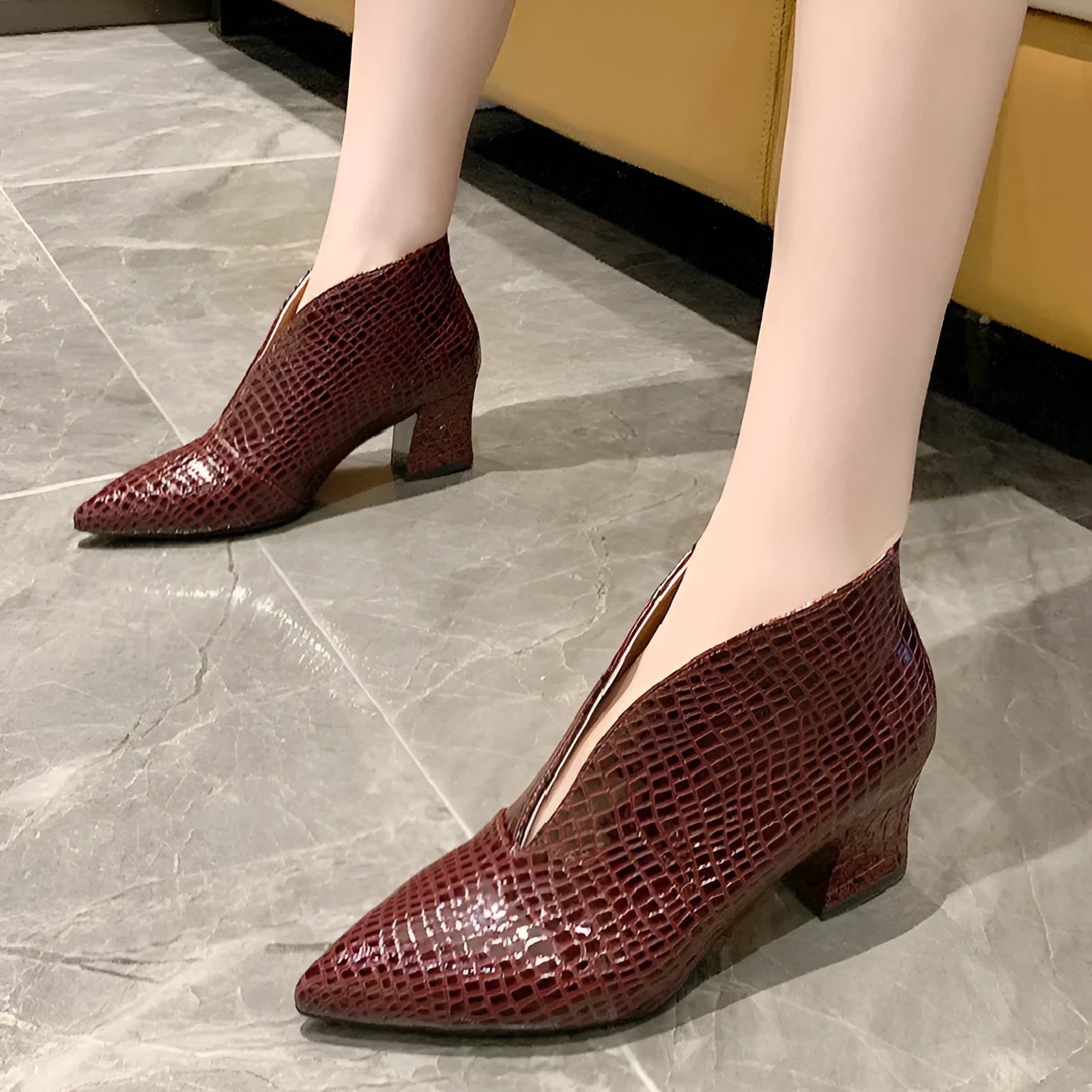 Black women's V-cut pointed ankle boots with an embossed PU upper and a chunky block heel.