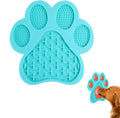 Bone-shaped blue silicone dog licking mat with suction cups on smooth surface