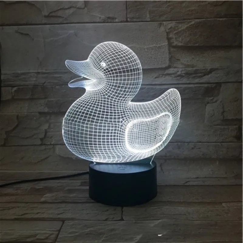 Little yellow duck 3D night light on table showing multiple colour options
