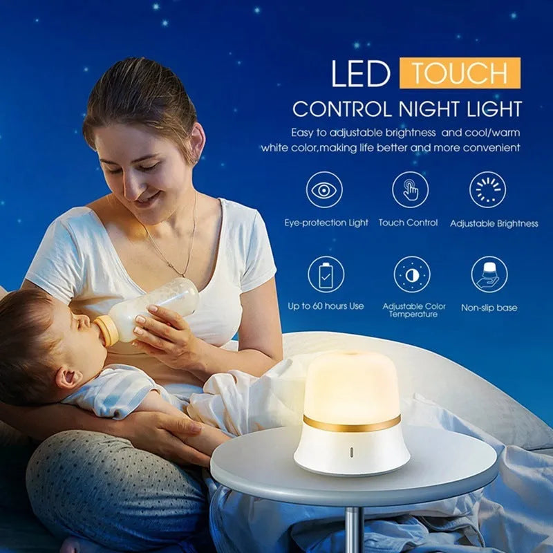 White rechargeable touch-control bedside night light with motion sensor on a table.