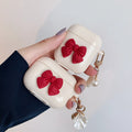 Beige AirPods case with red bow decoration, clamshell design for AirPods Pro and AirPods 3 models