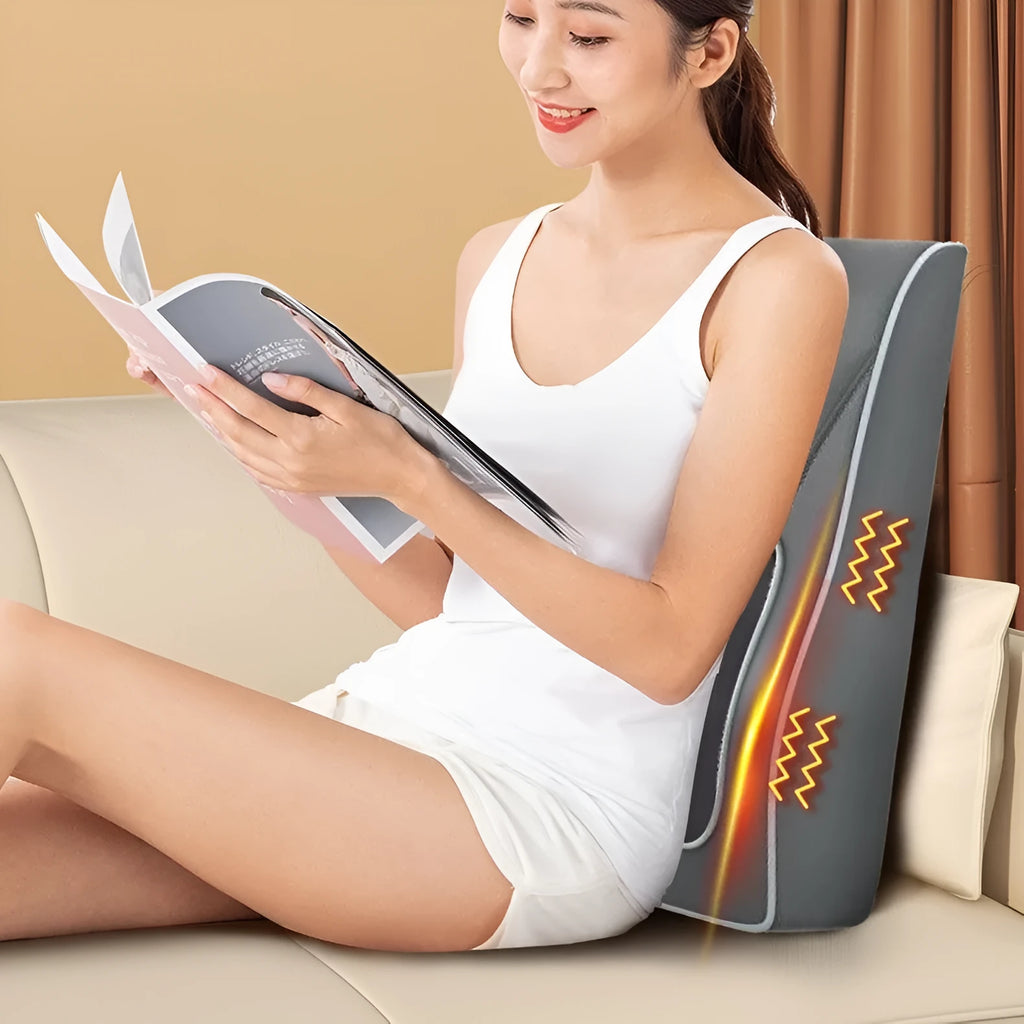 Heating electric magnetic therapy vibration massage pillow Deluxe Silver Grey edition with remote control on a chair