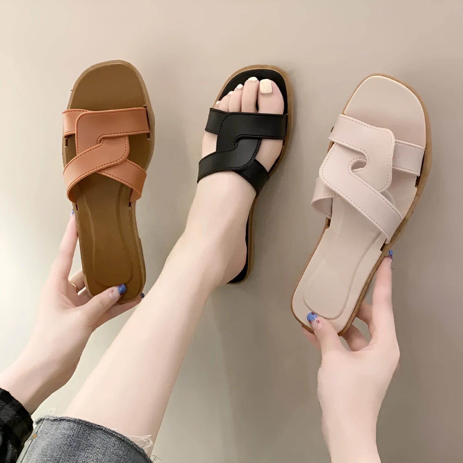 Women's PVC flip flop slippers with a cross strap and toe ring in a solid colour.
