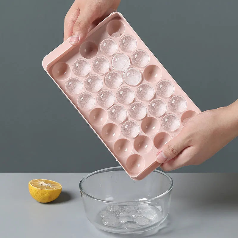 Sky blue round ball ice cube mould with 18 spherical cavities on a kitchen counter