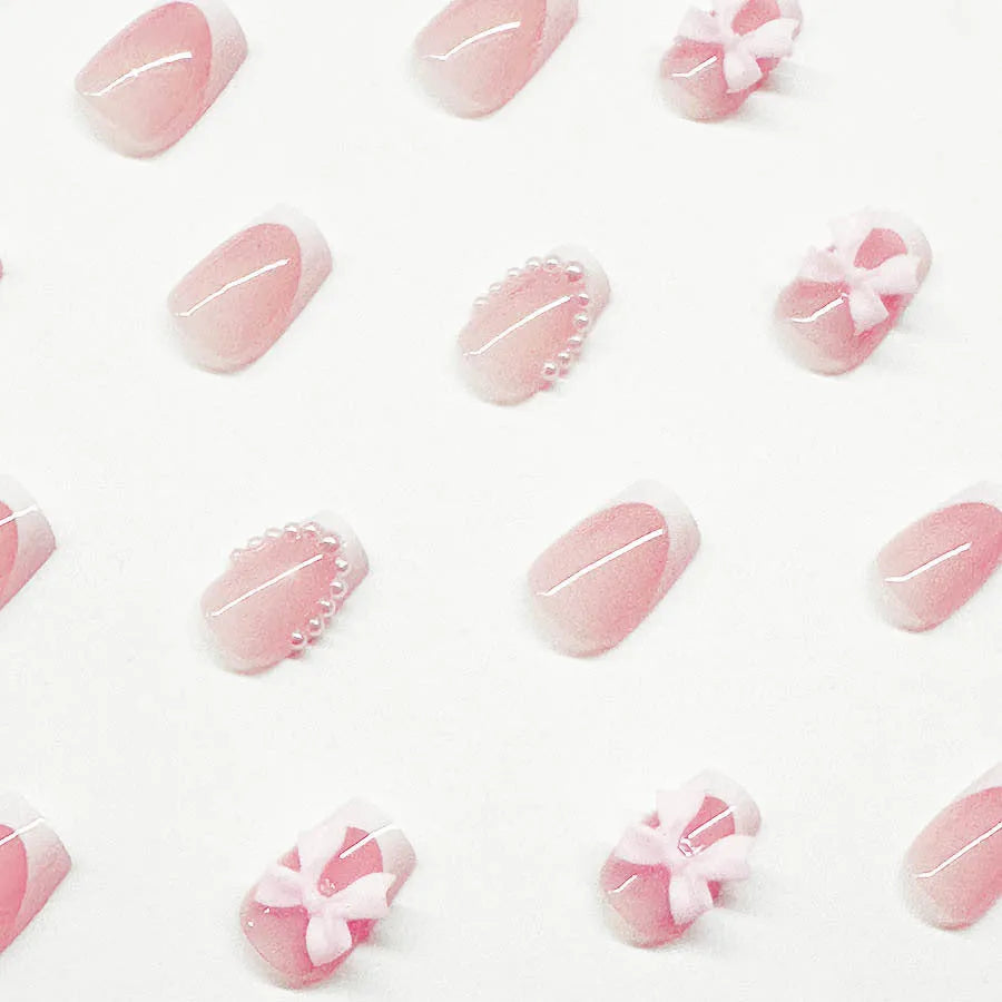 Short white French manicure press-on nails with bow, tulip, and starry sky decorative patterns