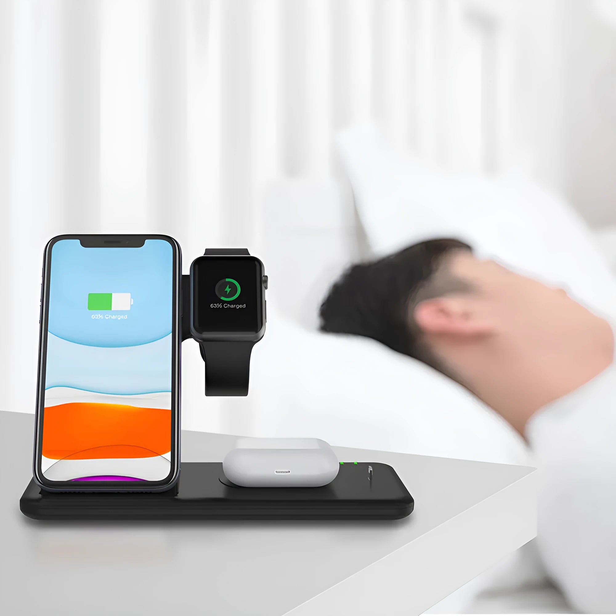 White three-in-one desktop wireless charging stand for mobile phone, smartwatch, and wireless earbuds.