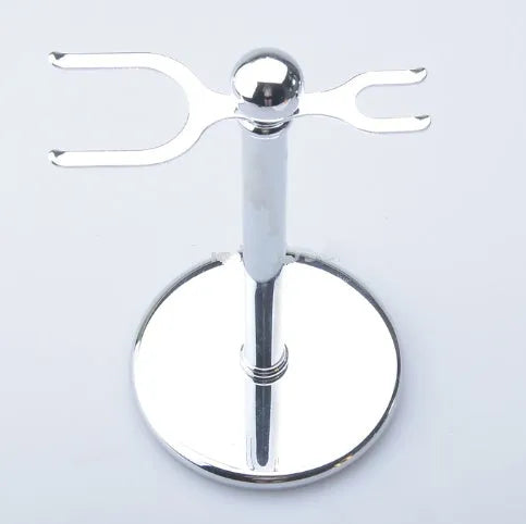 CSB shaving set with chrome stand holding a double edge safety razor and a badger hair brush, with a zinc alloy soap bowl and blades.