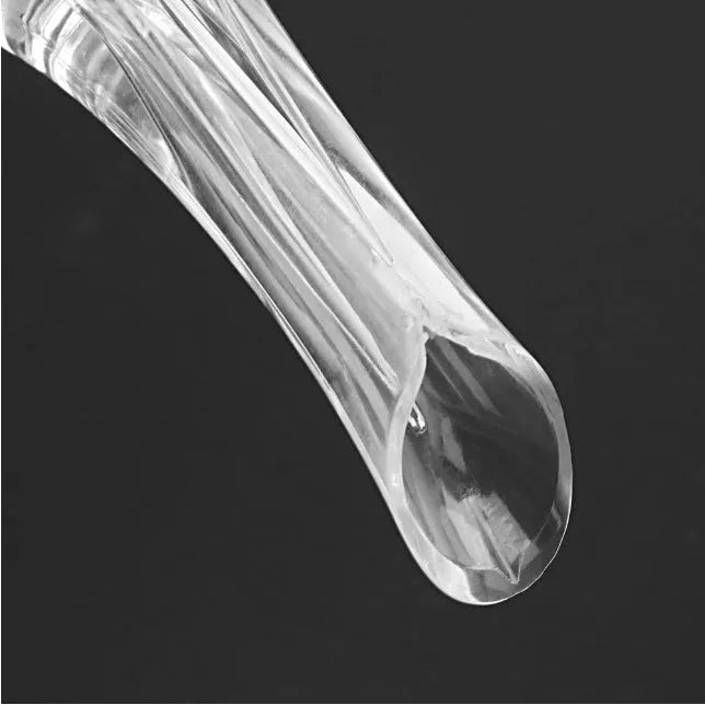 Clear acrylic wine aerator with stainless steel filter, shown next to a wine glass.