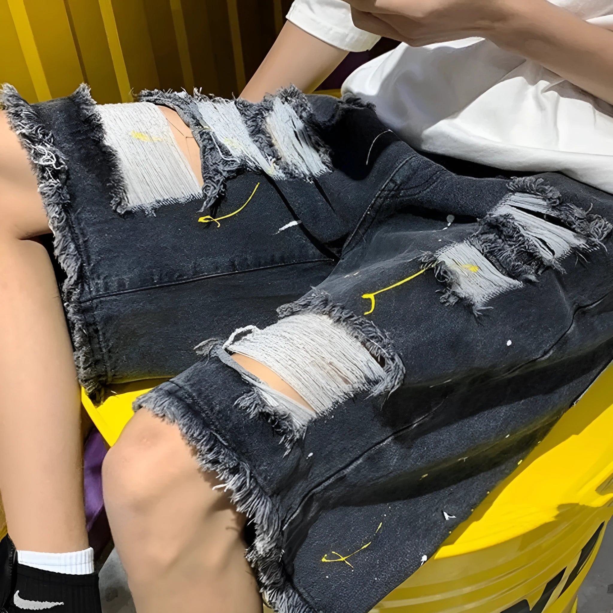 Men's black denim shorts with water-washed hole design and loose street style fit