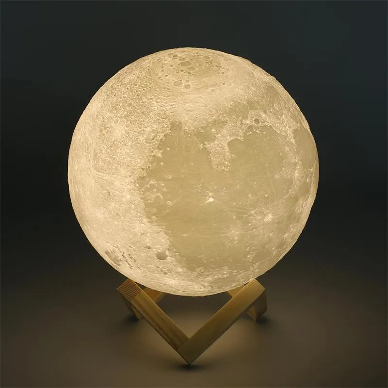 White 3D-printed moon lamp on a wooden stand with a visible textured surface.