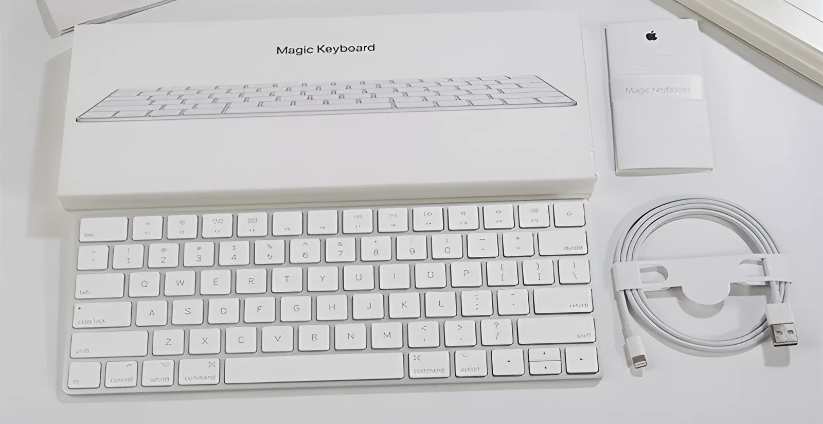 Genuine white Apple Bluetooth G6 wireless keyboard with ultra-thin metal build on a desk.