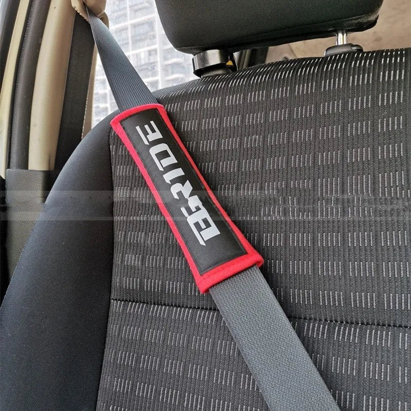 Car seat belt shoulder pad set in black, blue, or red colours with sponge padding and decorative embroidery