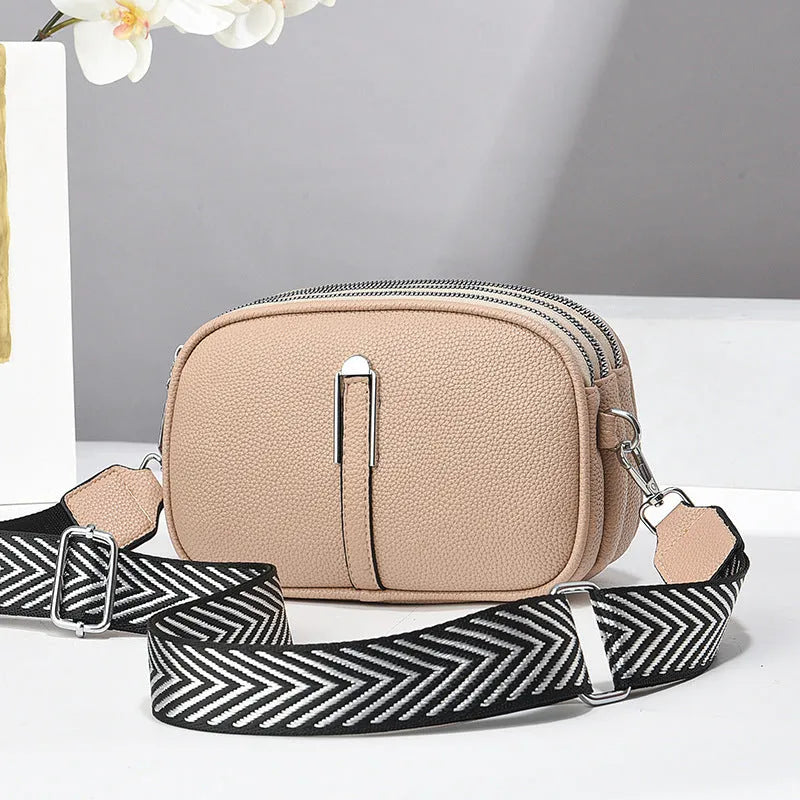 Soft PU leather women's oval crossbody bag showing slit pocket and internal organiser compartments