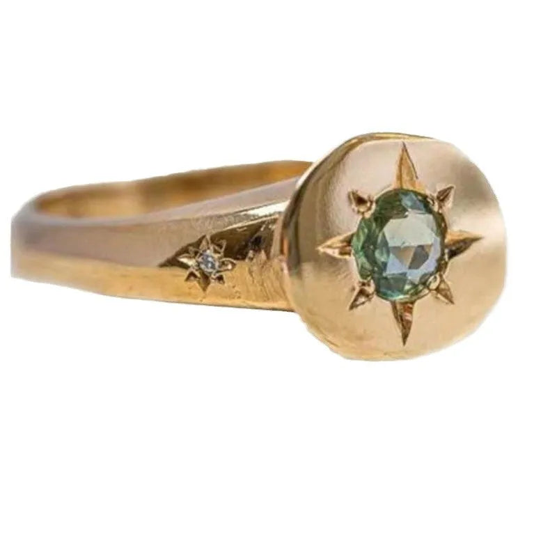Gold-coloured adjustable ring with a central oval star-shaped zircon stone on a simple band.