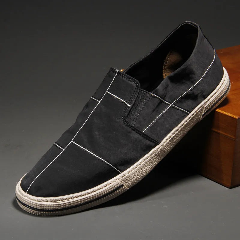 Men's low-top slip-on canvas shoes in khaki colour with a vulcanised rubber sole and rounded toe.