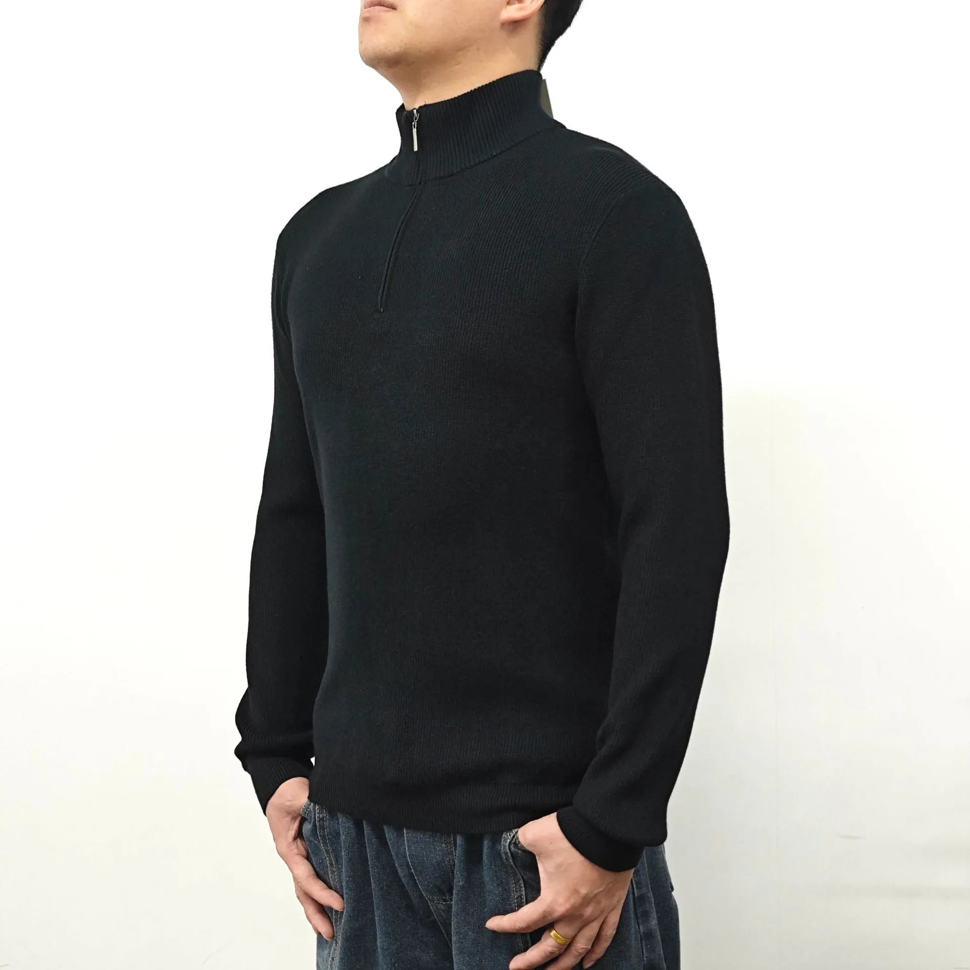 Men's black half turtleneck zipper sweater laid flat showing zip detail and long sleeves