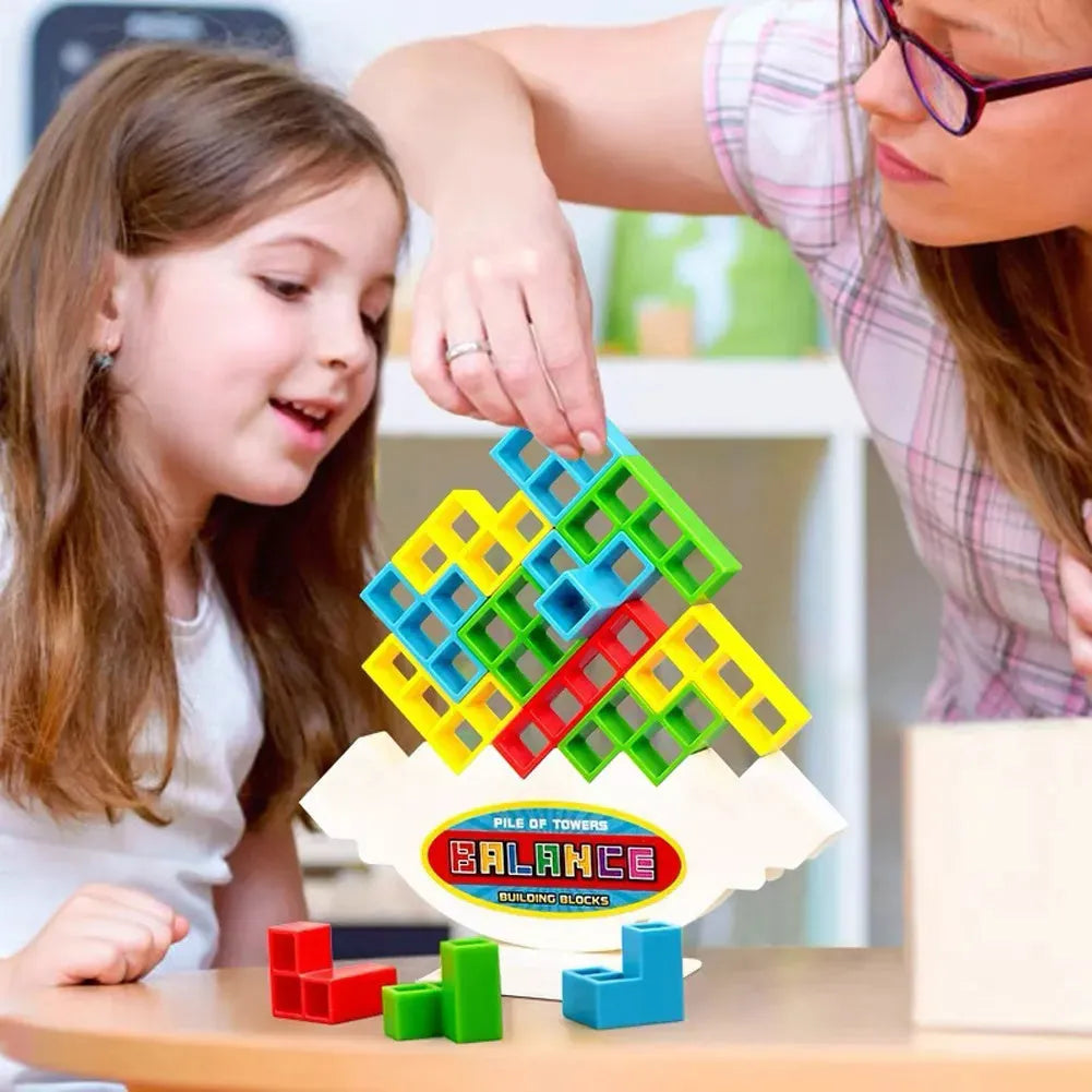 Plastic balance stacking game with colourful blocks, chassis, and base in packaging.