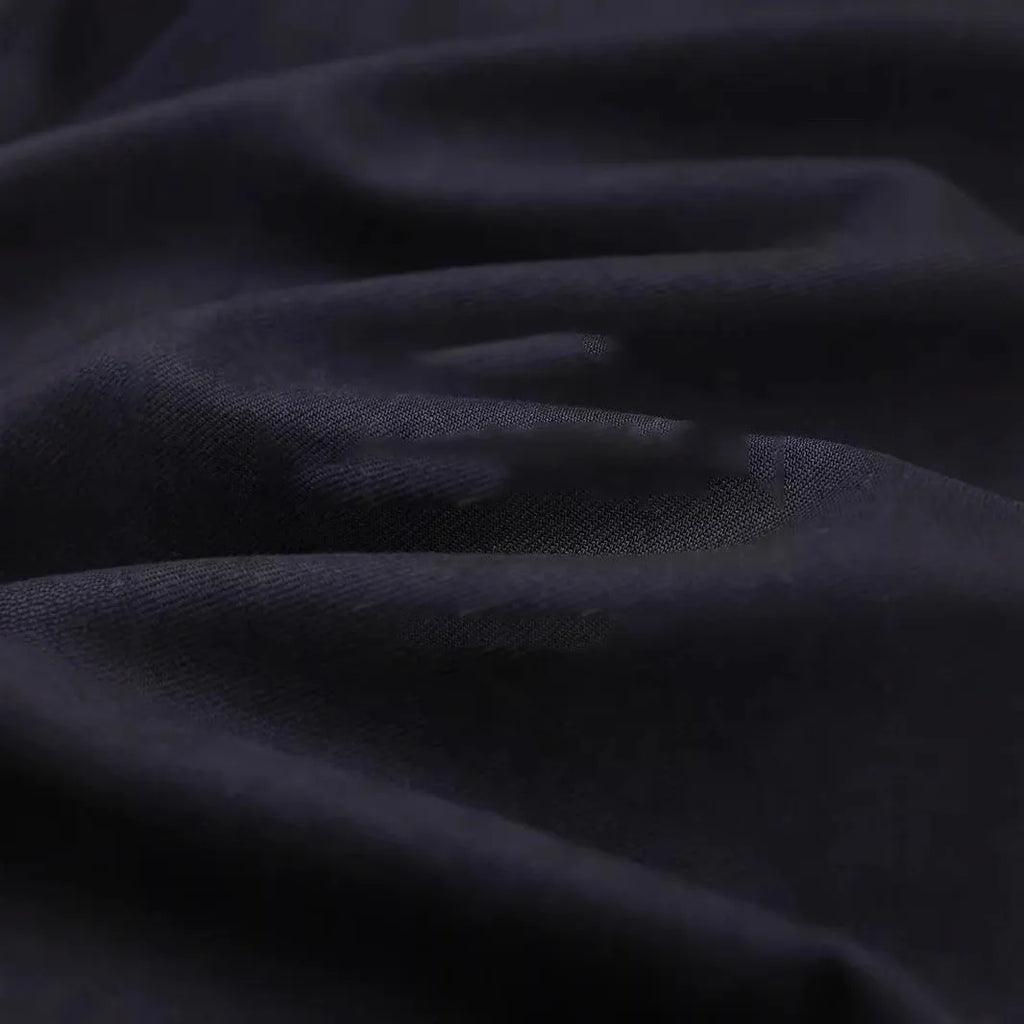 Men's light sand rice cotton lapel long sleeve shirt on a hanger.