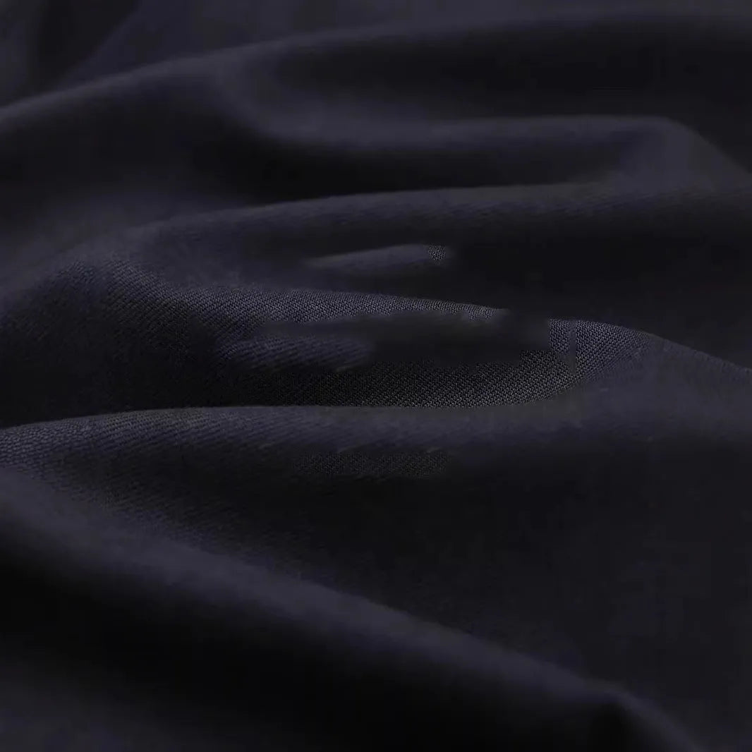 Men's light sand rice cotton lapel long sleeve shirt on a hanger.