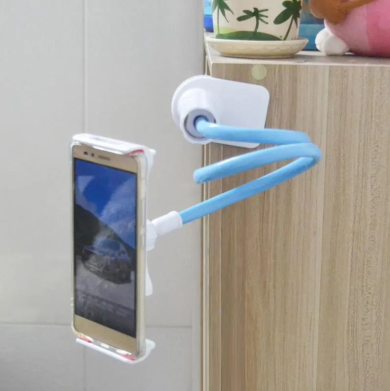 Black oversize bedside phone holder with a long adjustable arm mounted on a wooden table.