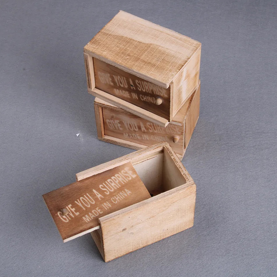 Wooden prank scare box with lid open showing a lifelike spider figurine on a spring.