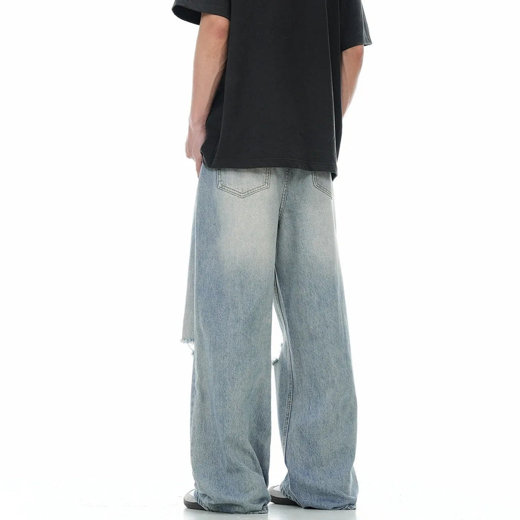 Man wearing blue retro-style distressed straight-leg cotton blend jeans.