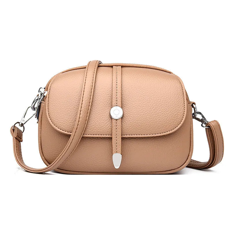 Soft black oval crossbody shoulder bag for women with visible stitching and a shoulder strap.