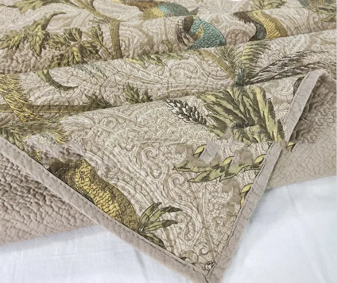 Blue American style floral bird quilted cotton bedspread set on a bed