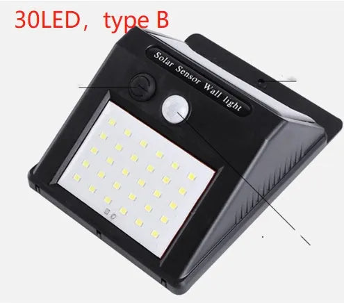 White solar-powered outdoor garden lamp with LED lights and a motion sensor on a black stake.