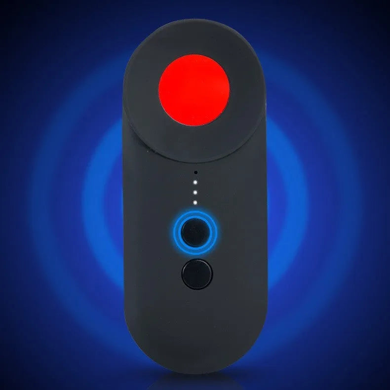 Black portable GPS and hidden camera detector with USB charging cable on a grey background.