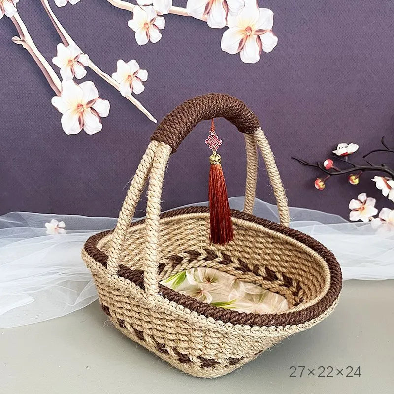Hand-woven straw basket with hemp rope binding in coffee brown colour, 19cm long by 12cm wide.