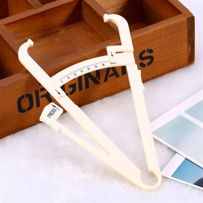 Transparent acrylic body fat caliper showing measurement scale up to 200mm