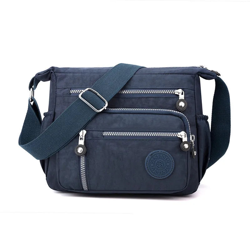 Grey nylon messenger bag with single shoulder strap showing square vertical shape