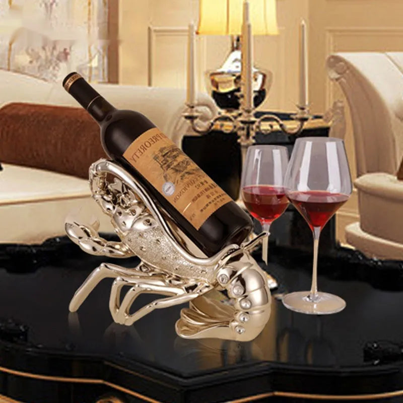 Decorative lobster-shaped wine rack ornament in rose gold or silver resin and plastic on a tabletop.