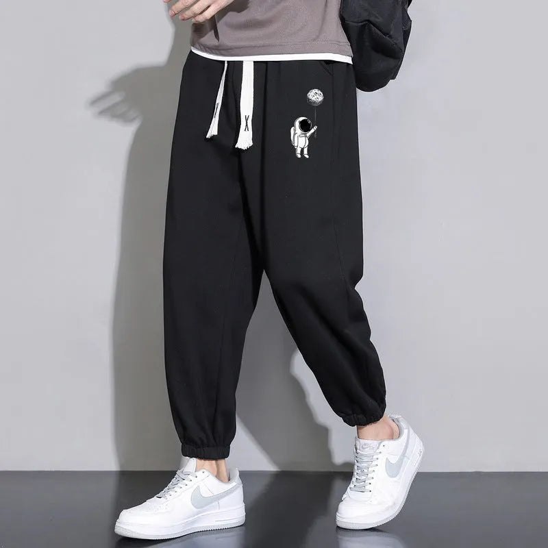Men's cropped casual loose tapered pants in black, 100% polyester, mid waist, cropped length, sizes M to 4XL.