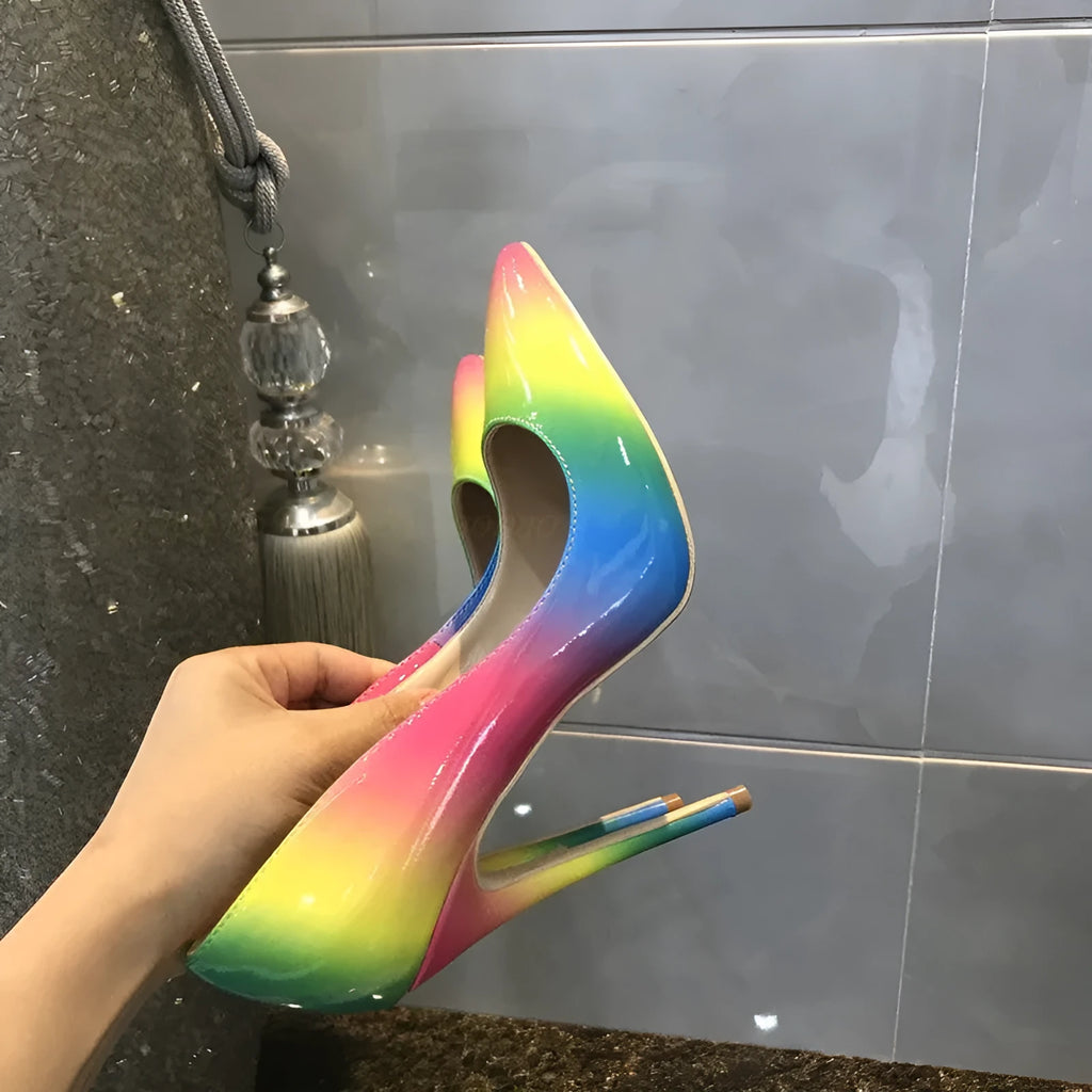 Rainbow coloured patent leather women's court shoes with a pointed toe and a thin ultra-high stiletto heel.